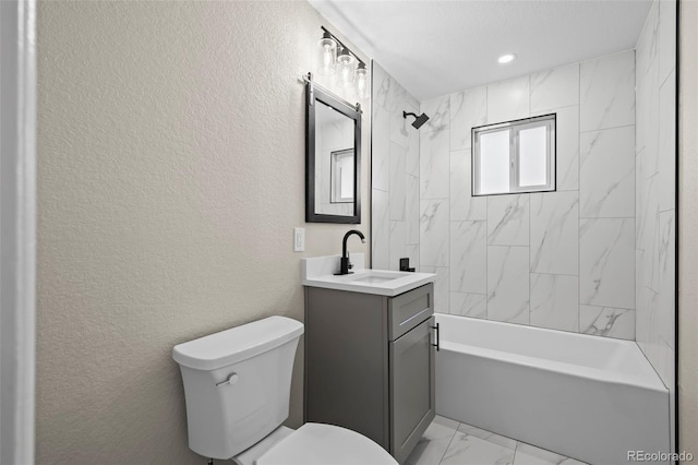 bathroom featuring toilet, washtub / shower combination, a textured wall, marble finish floor, and vanity