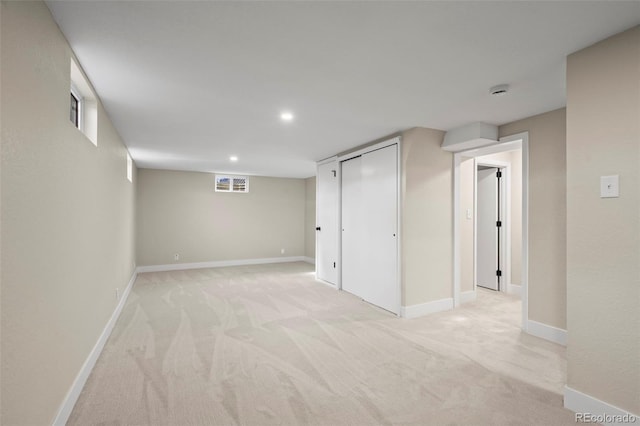 finished basement with light carpet, baseboards, visible vents, and recessed lighting