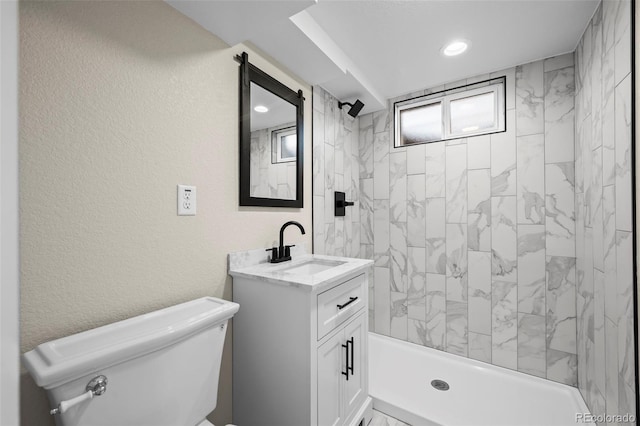 full bath with recessed lighting, toilet, vanity, a shower, and a textured wall