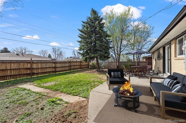 view of yard featuring a patio area, an outdoor living space with a fire pit, and a fenced backyard