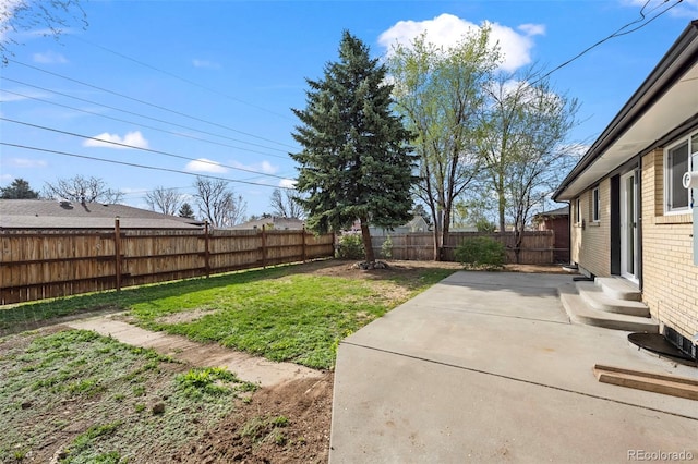 view of yard featuring a fenced backyard, entry steps, and a patio area