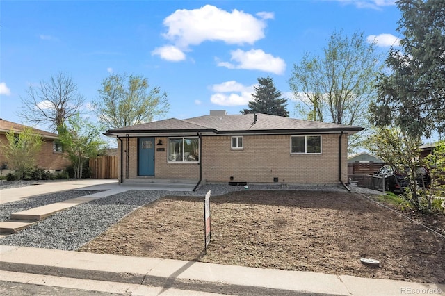 view of front of property featuring brick siding and fence