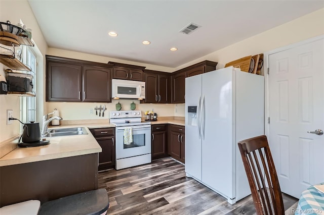 5535 Flanders Way, Denver, CO 80249 - kitchen featuring white appliances, dark brown cabinetry, light countertops, dark wood finished floors, and recessed lighting