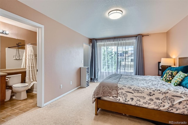 5535 Flanders Way, Denver, CO 80249 - bedroom featuring carpet flooring, ensuite bath, and tile patterned floors