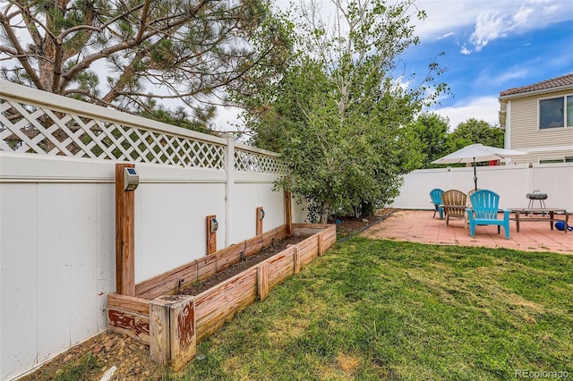 5535 Flanders Way, Denver, CO 80249 - fenced backyard with a patio area and a garden