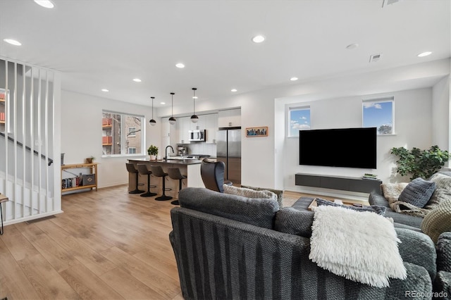 3101 W 47th Ave Unit 14, Denver, CO 80211 - living room featuring light wood-style floors, stairway, and recessed lighting