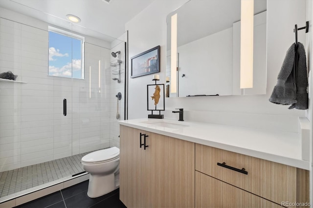 3101 W 47th Ave Unit 14, Denver, CO 80211 - full bathroom featuring toilet, a baseboard radiator, a shower stall, tile patterned flooring, and vanity