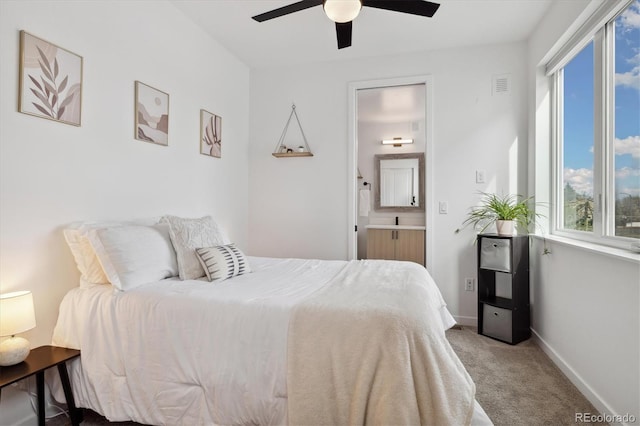 3101 W 47th Ave Unit 14, Denver, CO 80211 - bedroom featuring carpet floors, connected bathroom, baseboards, and ceiling fan