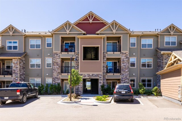 9992 W Victoria Pl Unit 103, Littleton, CO 80127 - view of property featuring uncovered parking