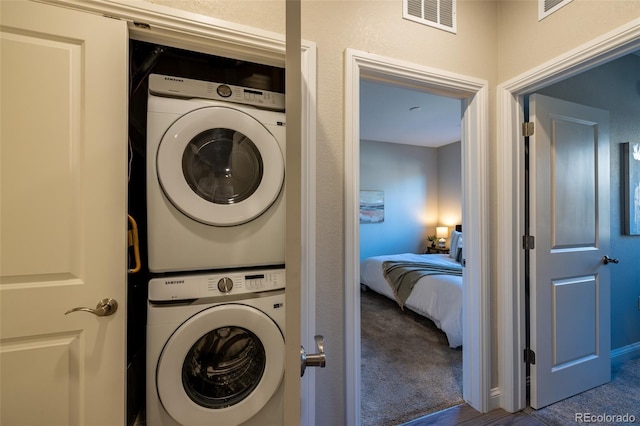 9992 W Victoria Pl Unit 103, Littleton, CO 80127 - laundry area featuring stacked washer / dryer and carpet floors