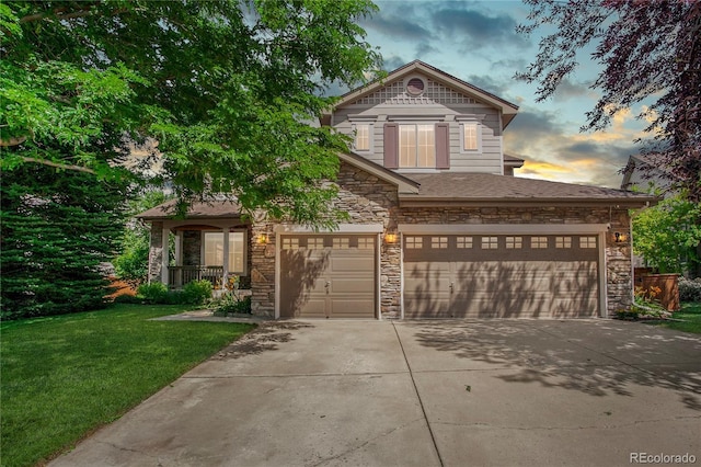 9644 S Estes Way, Littleton, CO 80127 - view of front of home featuring stone siding, a front lawn, concrete driveway, and a garage