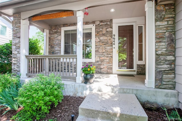 9644 S Estes Way, Littleton, CO 80127 - property entrance featuring stone siding and a porch