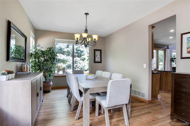 9644 S Estes Way, Littleton, CO 80127 - dining area featuring a chandelier and light wood-style flooring