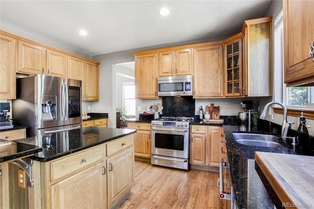 9644 S Estes Way, Littleton, CO 80127 - kitchen featuring stainless steel appliances, light brown cabinets, glass insert cabinets, light wood-type flooring, and recessed lighting