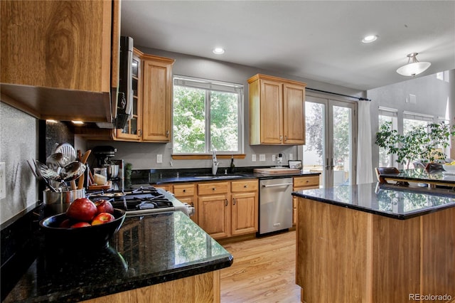 9644 S Estes Way, Littleton, CO 80127 - kitchen with dishwasher, light wood-style floors, recessed lighting, glass insert cabinets, and dark stone counters
