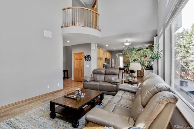 9644 S Estes Way, Littleton, CO 80127 - living area with a towering ceiling, light wood finished floors, and recessed lighting