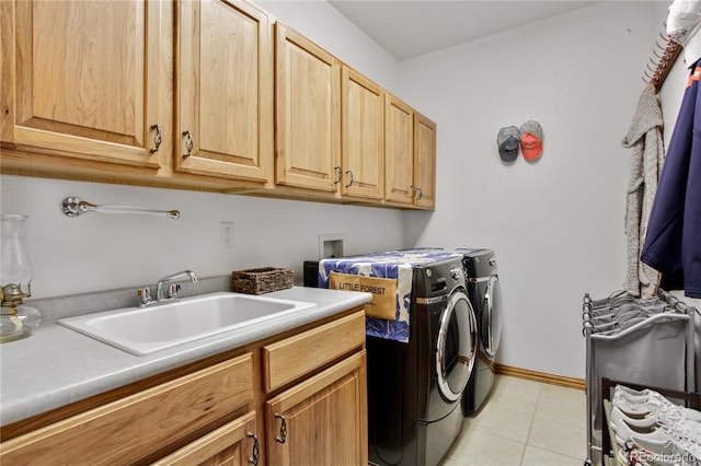 9644 S Estes Way, Littleton, CO 80127 - washroom featuring cabinet space, washing machine and clothes dryer, and light tile patterned floors