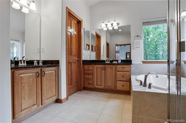 9644 S Estes Way, Littleton, CO 80127 - full bathroom featuring two vanities, a garden tub, and tile patterned floors