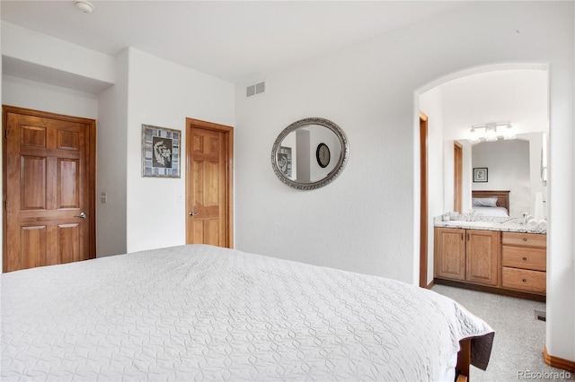 9644 S Estes Way, Littleton, CO 80127 - bedroom featuring arched walkways, carpet flooring, and ensuite bath
