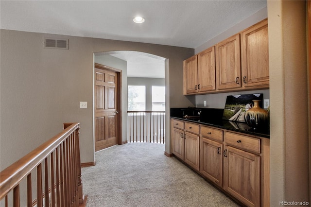9644 S Estes Way, Littleton, CO 80127 - hallway with arched walkways, light carpet, and recessed lighting