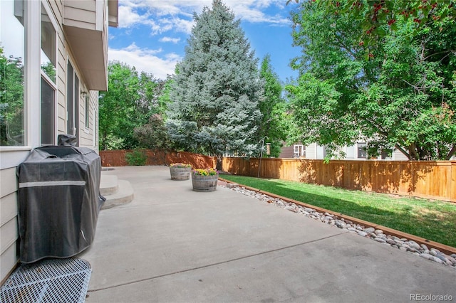 9644 S Estes Way, Littleton, CO 80127 - fenced backyard featuring a patio area and area for grilling