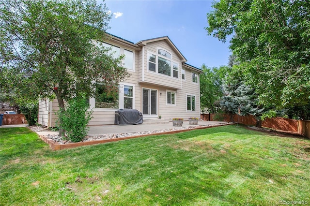 9644 S Estes Way, Littleton, CO 80127 - rear view of house featuring a patio area and a fenced backyard