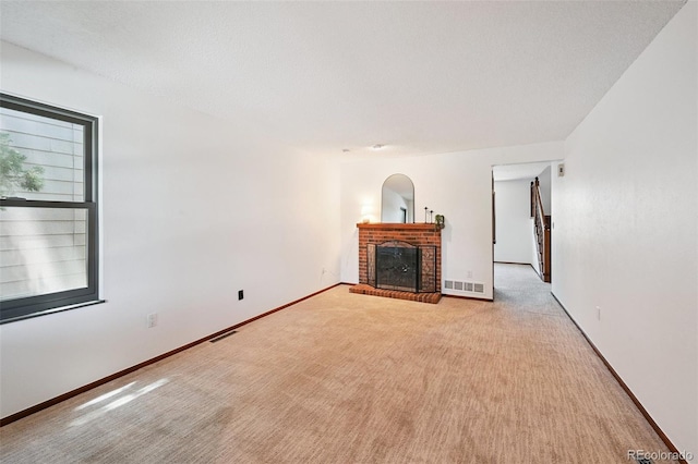 9125 Lowell Ct, Westminster, CO 80031 - unfurnished living room featuring a brick fireplace and light colored carpet