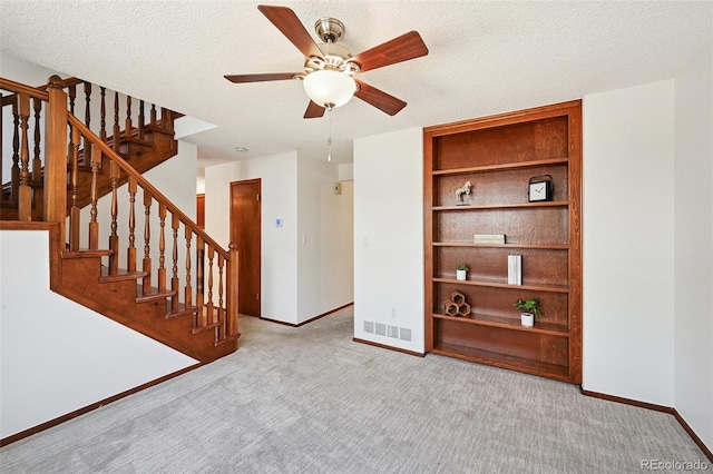 9125 Lowell Ct, Westminster, CO 80031 - carpeted empty room featuring ceiling fan, stairs, a textured ceiling, and built in features