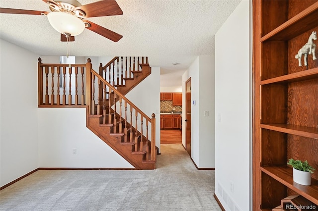 9125 Lowell Ct, Westminster, CO 80031 - stairs with carpet, a textured ceiling, and ceiling fan