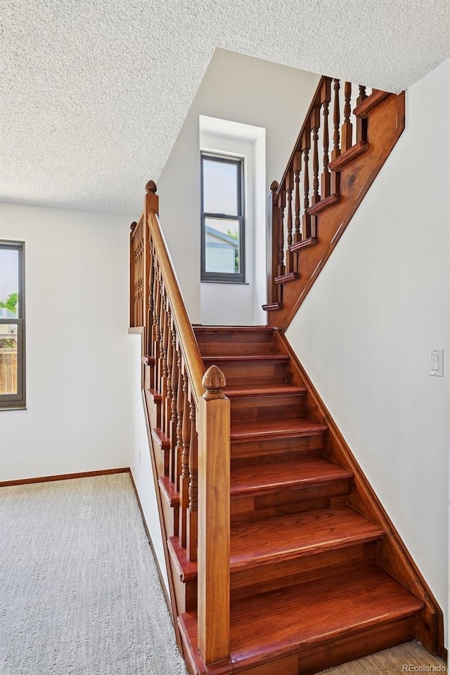 9125 Lowell Ct, Westminster, CO 80031 - stairs featuring a textured ceiling, plenty of natural light, and carpet