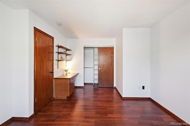9125 Lowell Ct, Westminster, CO 80031 - unfurnished bedroom with dark wood finished floors, a desk, and a textured ceiling