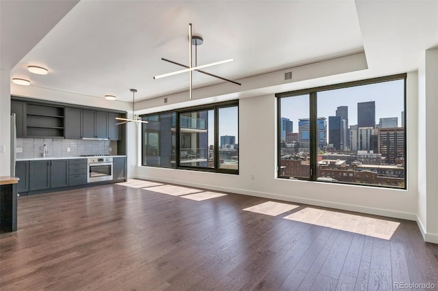1750 Wewatta St Unit 1102, Denver, CO 80202 - unfurnished living room featuring dark wood-style floors and a skyline view