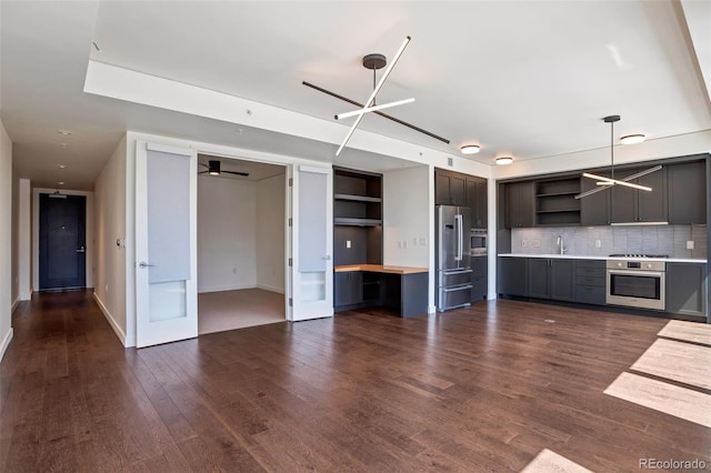 1750 Wewatta St Unit 1102, Denver, CO 80202 - kitchen featuring open shelves, appliances with stainless steel finishes, dark wood-type flooring, decorative backsplash, and decorative light fixtures