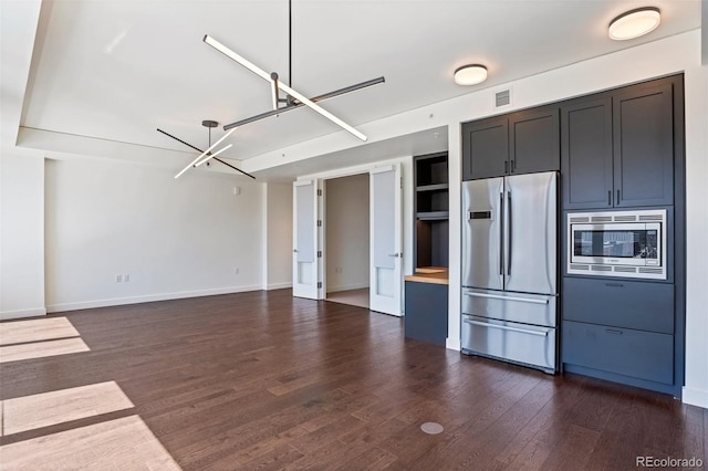1750 Wewatta St Unit 1102, Denver, CO 80202 - kitchen featuring stainless steel appliances, dark wood-type flooring, built in features, light countertops, and open floor plan