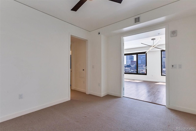 1750 Wewatta St Unit 1102, Denver, CO 80202 - spare room featuring a ceiling fan, carpet, and a chandelier