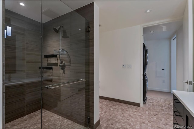 1750 Wewatta St Unit 1102, Denver, CO 80202 - bathroom with stacked washer / drying machine, vanity, a stall shower, recessed lighting, and tile patterned flooring