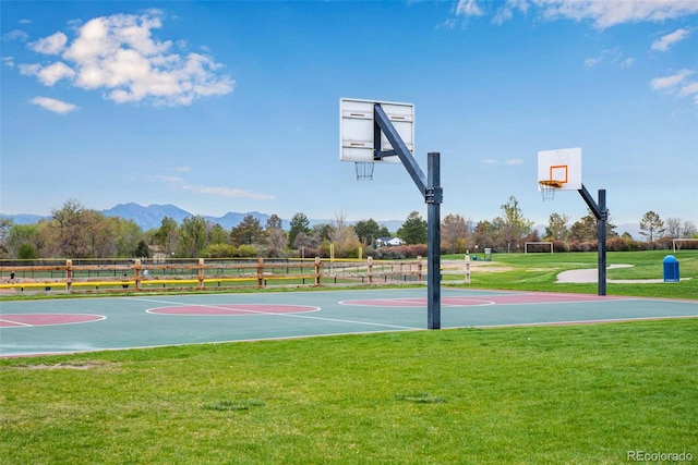 9980 Newton Ct, Westminster, CO 80031 - view of sport court with a yard, a mountain view, fence, and community basketball court