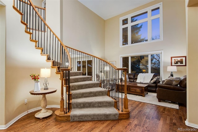 9980 Newton Ct, Westminster, CO 80031 - staircase with baseboards, wood finished floors, and a towering ceiling