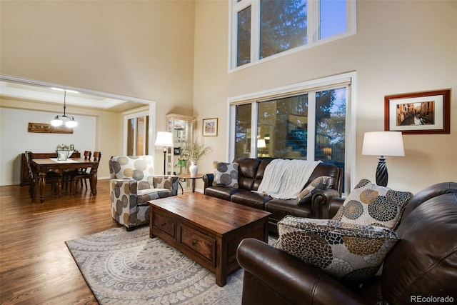 9980 Newton Ct, Westminster, CO 80031 - living area with a chandelier, crown molding, a towering ceiling, and wood finished floors