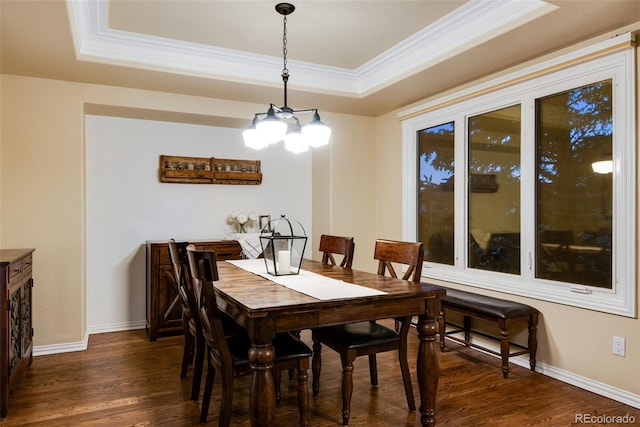 9980 Newton Ct, Westminster, CO 80031 - dining area with ornamental molding, an inviting chandelier, dark wood-style flooring, a tray ceiling, and baseboards