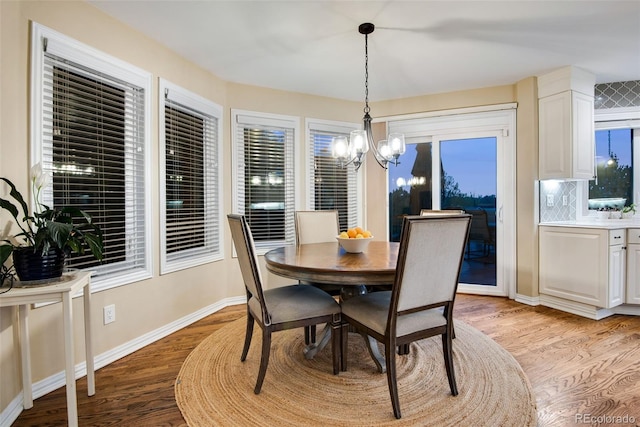 9980 Newton Ct, Westminster, CO 80031 - dining space with light wood finished floors, an inviting chandelier, and baseboards