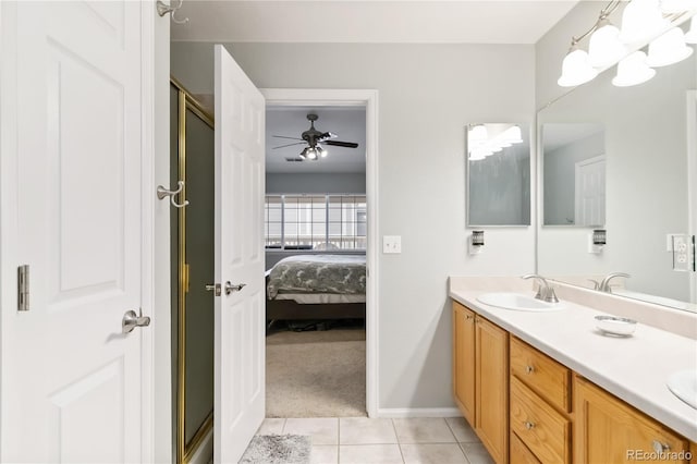 bathroom featuring double vanity, a ceiling fan, tile patterned flooring, a sink, and ensuite bathroom