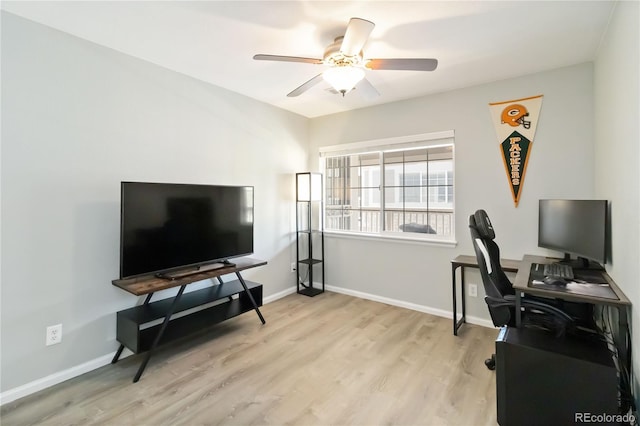office space with ceiling fan, baseboards, and light wood-type flooring