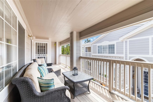 wooden deck with an outdoor living space