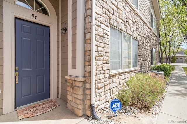 property entrance with stone siding