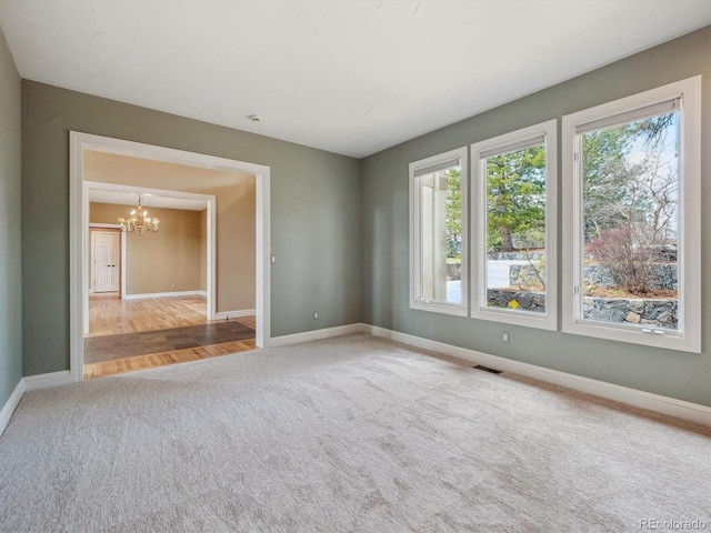 902 Anaconda Ct, Castle Rock, CO 80108 - carpeted empty room featuring an inviting chandelier, baseboards, and visible vents