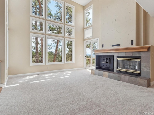 902 Anaconda Ct, Castle Rock, CO 80108 - unfurnished living room featuring baseboards, carpet, and a towering ceiling