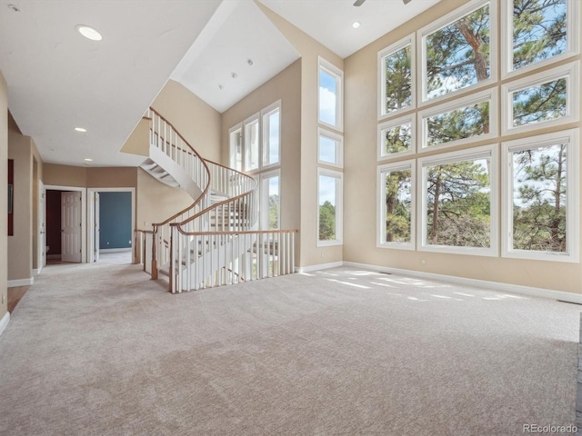 902 Anaconda Ct, Castle Rock, CO 80108 - unfurnished living room with baseboards, a healthy amount of sunlight, and carpet