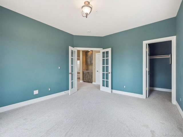902 Anaconda Ct, Castle Rock, CO 80108 - unfurnished bedroom with baseboards, carpet flooring, a closet, and french doors