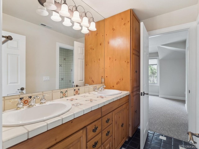 902 Anaconda Ct, Castle Rock, CO 80108 - bathroom featuring tile patterned flooring, visible vents, a sink, and double vanity